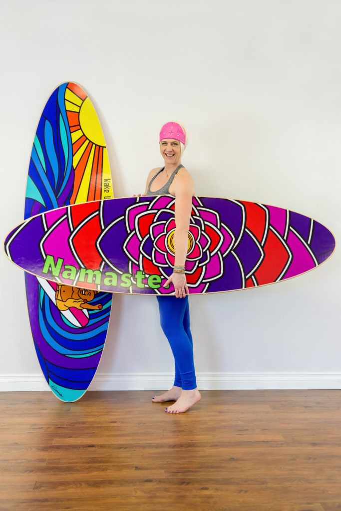 Karma SUPtra founder Julie Thayer with SUP Yoga boards
