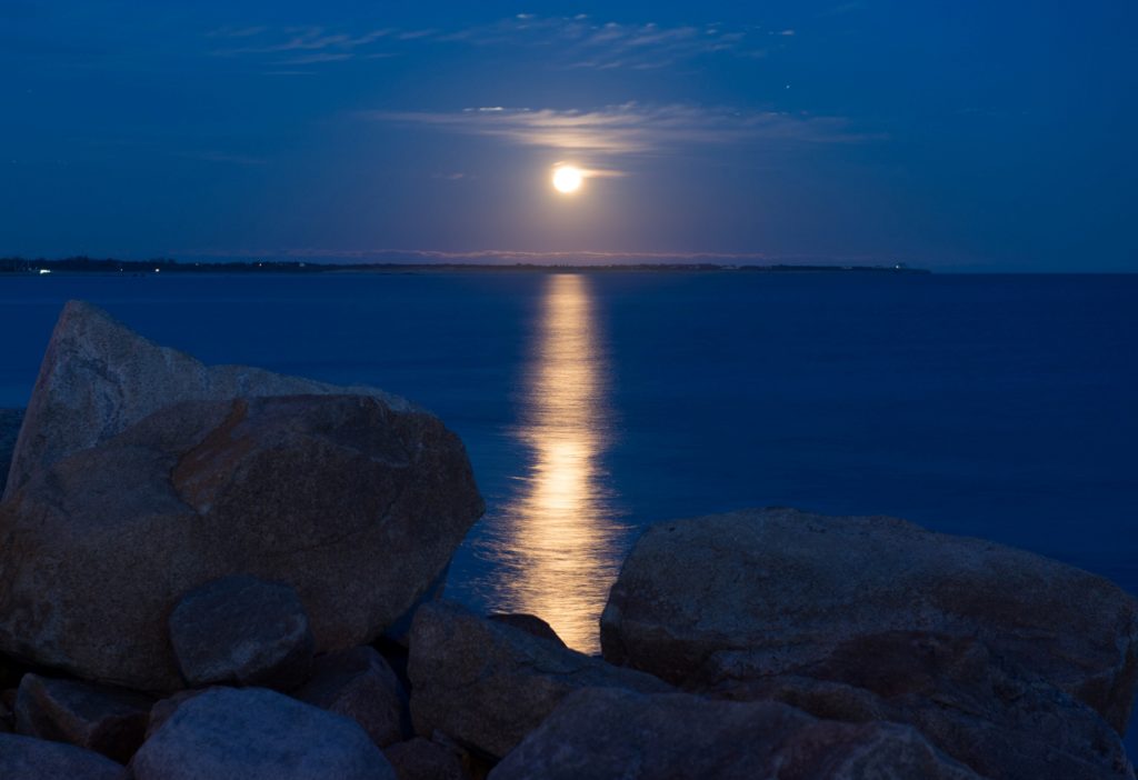 Full moon over water by Benji